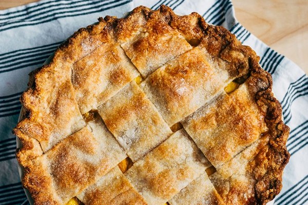 Wide lattice peach pie with tarragon butter