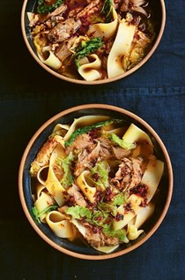 Wide noodles with lamb shank in aromatic broth