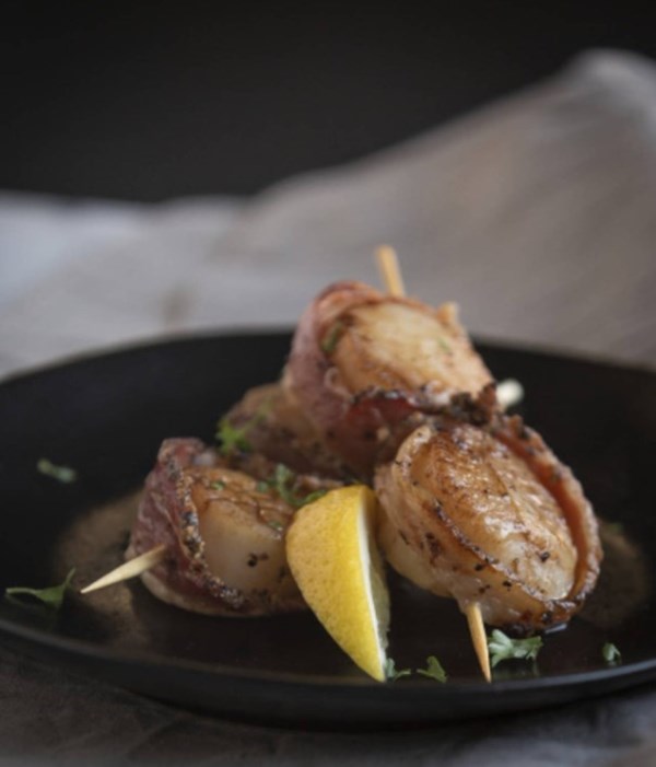 Wild boar-wrapped scallop skewers 
