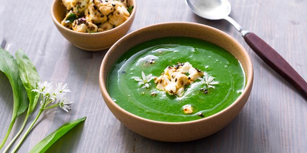 Wild garlic, new potato and black onion seed soup with marinated feta