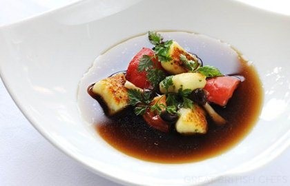 Wild mushroom consommé with herb gnocchi, confit tomatoes and pickled mushrooms