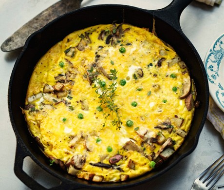 Wild mushroom frittata with cheddar, green onions, and peas