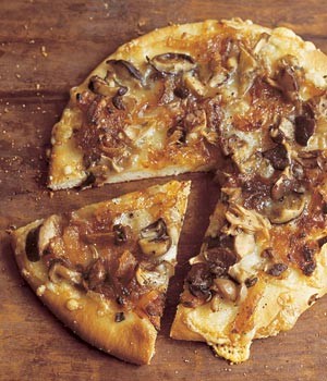 Wild mushroom pizzas with caramelized onions, Fontina, and rosemary