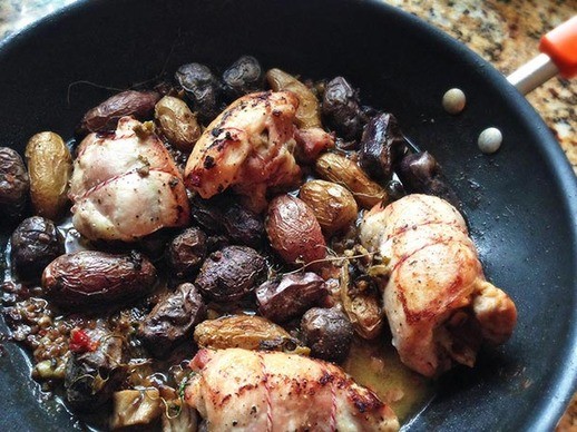 Wild mushroom-stuffed chicken thighs with fingerling potatoes and green olives
