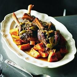 Wine-braised lamb knuckles with green olives and gremolata