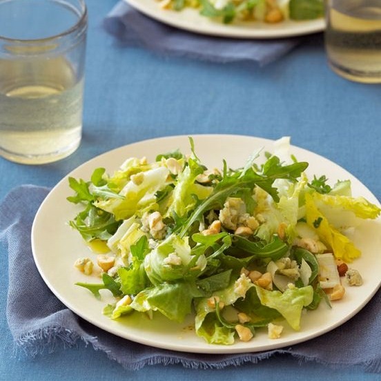 Winter green and white side salad with blue cheese and hazelnuts