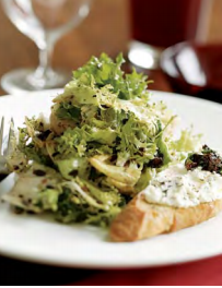 Winter greens with black olive vinaigrette and warm marinated goat cheese croutons
