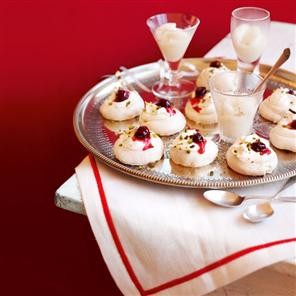 Winter pavlova with boozy cranberries and orange cream