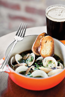 Wood-fired clams with Holy City porter beer broth, shiitake mushrooms, kale & crispy toast