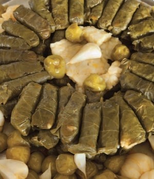 Wrapped vine leaves with green plums (Can erikli yaprak sarma)