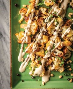 Zesty cauliflower, pine nuts, and currants with tahini-yogurt sauce