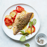 Zesty sea bream with potato and tomato bake