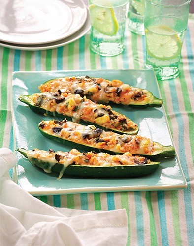 Zucchini boats with tomato, rice, and olives