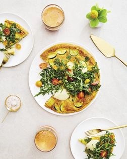 Zucchini curry tortilla with arugula salad